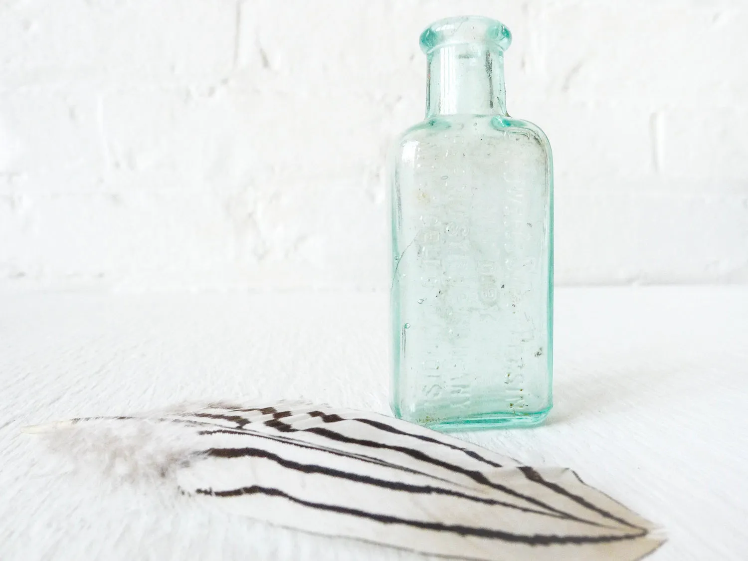 Antique Cadwell Medicine Bottle with Zebra Chicken Feather Specimen